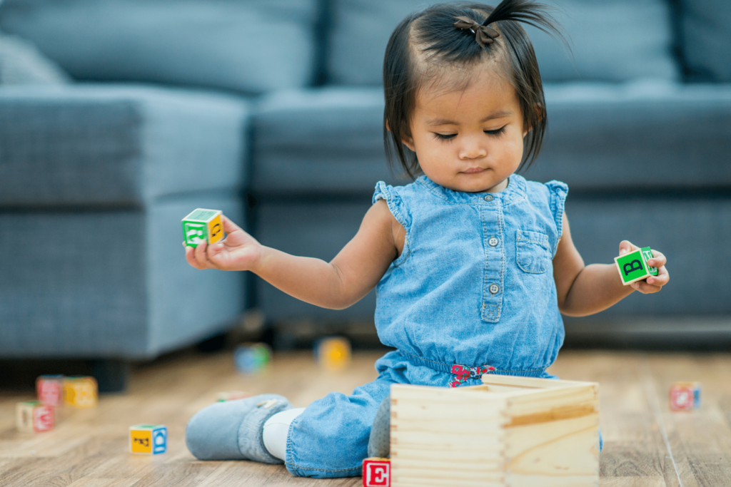 Toddler independently playing with blocks