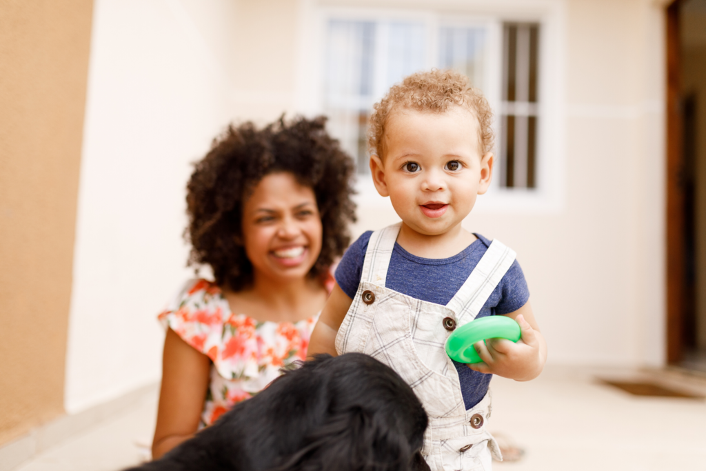 Young boy outside with mom