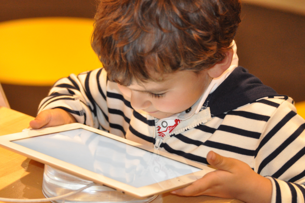 young boy looking at tablet